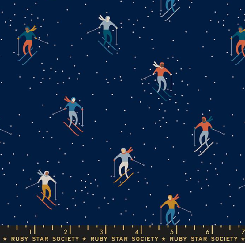 Winterglow by Alexia Marcelle Abegg Ruby Star Society quilt weight cotton navy background skiers with blue gray white orange sweaters and snow falling
