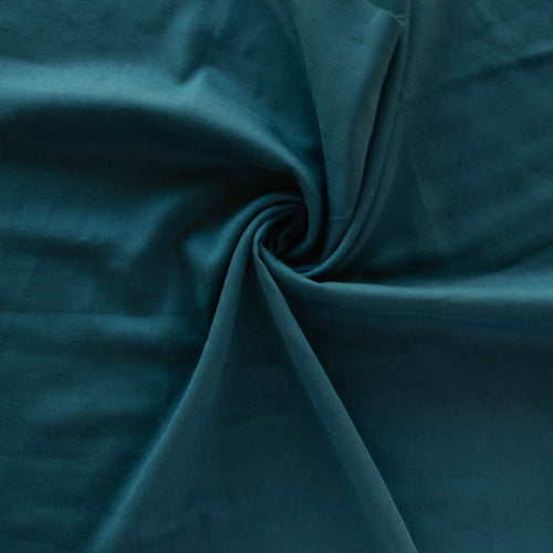 Organic cotton double gauze by Birch Fabrics in the color Abyss a rich teal blue green perfect for a baby blanket swaddle or garments tank top blouse skirt