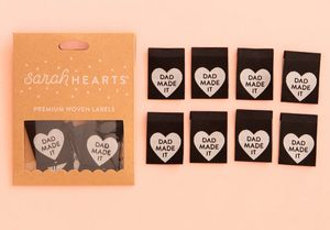 Woven label by Sarah Hearts black background with silver white heart and Dad Made It in type inside the heart for clothing garments bags costumes totes 