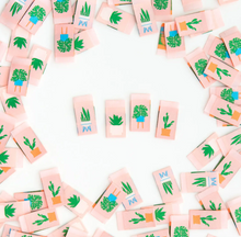 Load image into Gallery viewer, Woven labels by Sarah Hearts with bright green succulents and houseplants in modern blue white and terra cotta containers centerfold double sided design soft and machine washable for use in garments quilts clothing purses bags and sewing projects 
