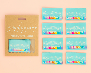 Sarah Heart double fold premium labels for quilts garments clothing bags sewing projects Quiliting is My Superpower in rainbow colors on aqua blue background