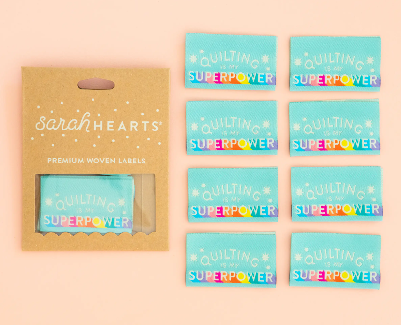 Sarah Heart double fold premium labels for quilts garments clothing bags sewing projects Quiliting is My Superpower in rainbow colors on aqua blue background
