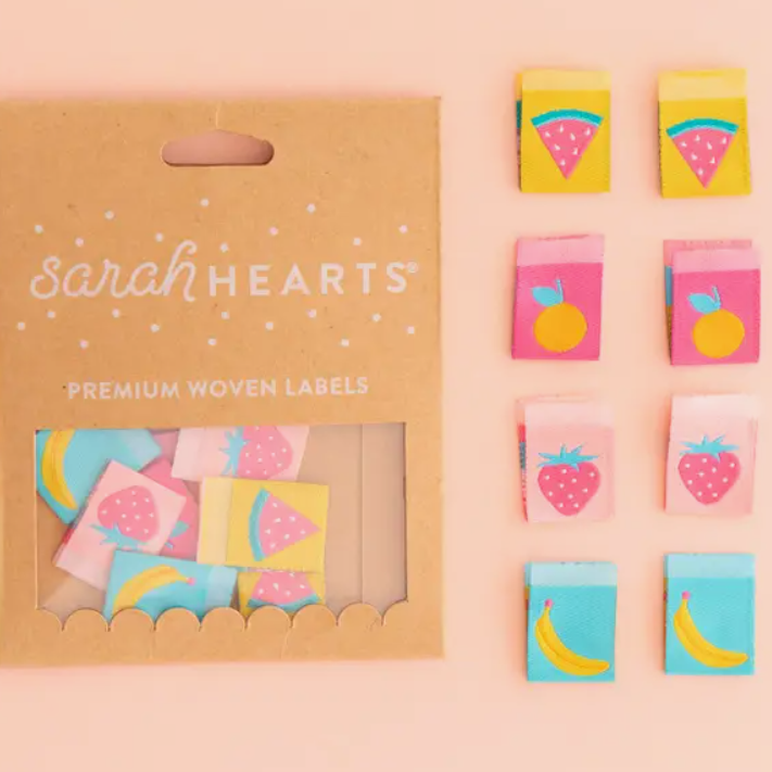 Sarah Hearts Summer Fruits woven double sided labels for garments clothing bags quilts multi-colored backgrounds of yellow pink aqua with watermelon slice strawberry banana and orange