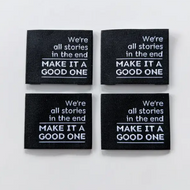 We're all stories in the end make it a good one black label with white print text by Intensely Distracted for quilts, garments, bags sewing
