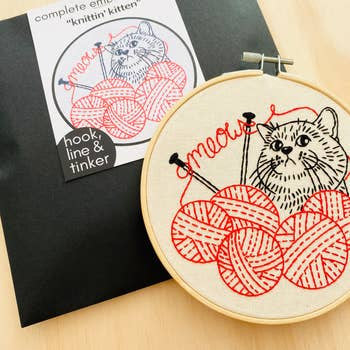 Knittin' Knitting Kitten embroidery kit Meow skeins balls of yarn knitting needles playful kitten red and black needle thread hoop pre-printed cotton fabric by Hook Line & Tinker Nova Scotia Canada